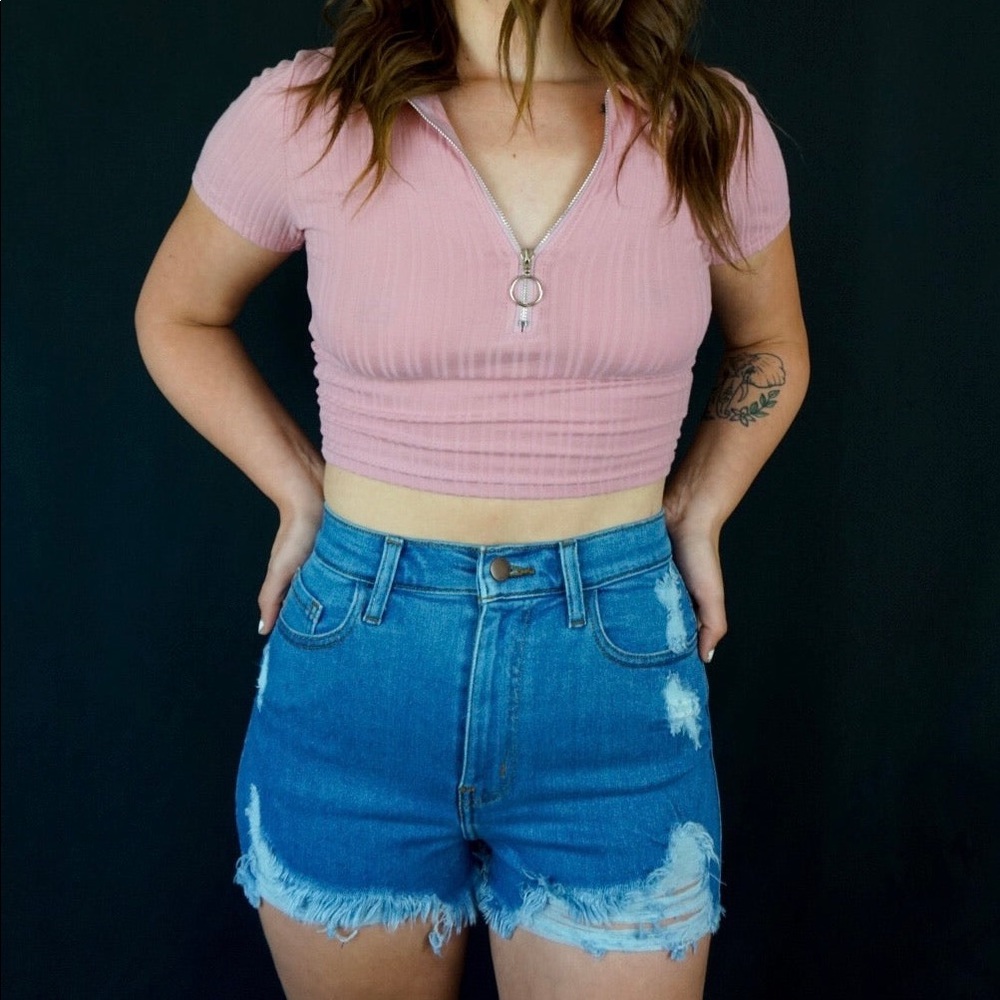 Medium wash stretch denim shorts with distressing detail